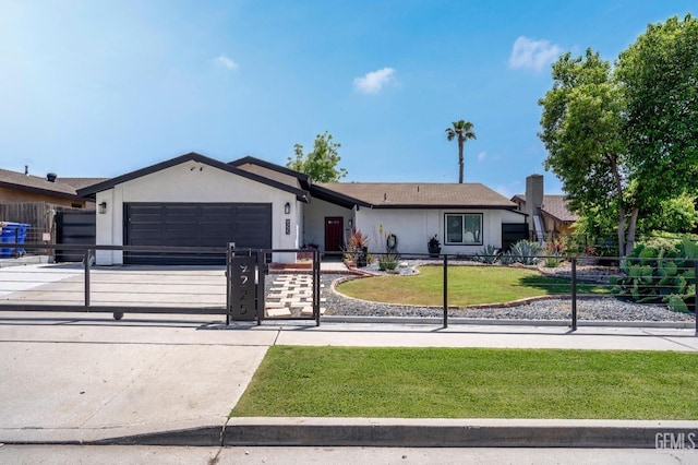 ranch-style house featuring a garage and a front yard