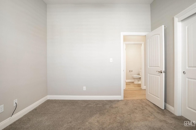 unfurnished bedroom with baseboards and carpet floors