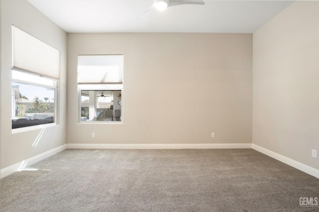 unfurnished room featuring baseboards, carpet, and ceiling fan