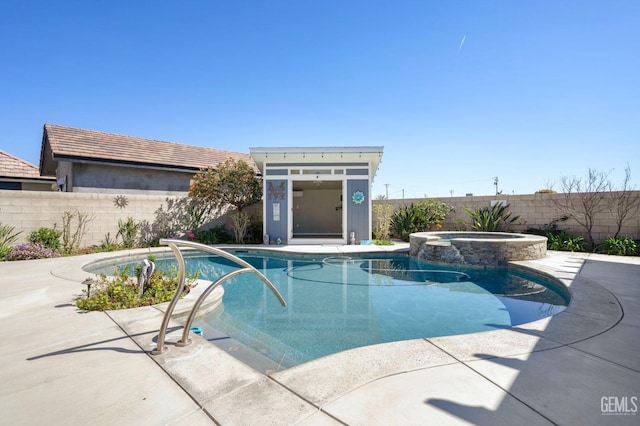 view of swimming pool with a patio, an outdoor structure, a fenced backyard, and a pool with connected hot tub