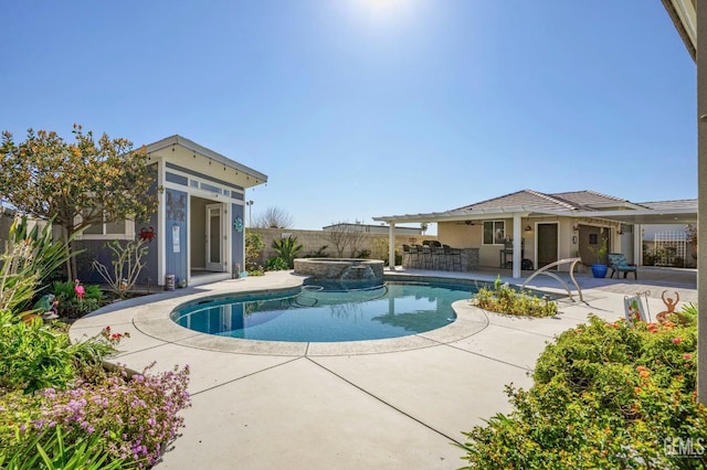 view of swimming pool with outdoor dry bar, a pool with connected hot tub, a fenced backyard, a patio area, and an outbuilding