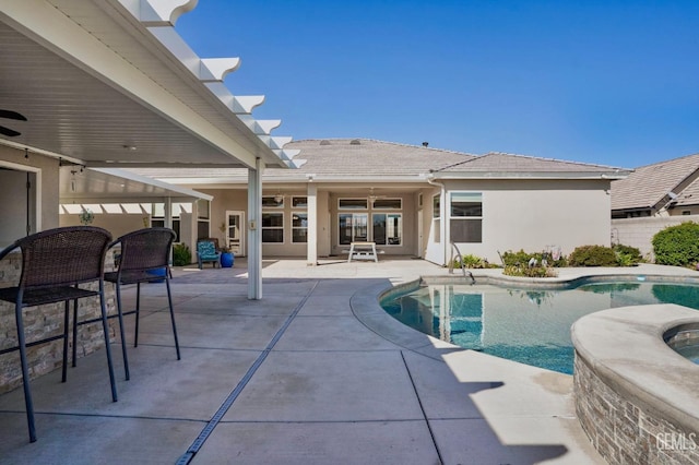 view of pool with a patio, a fenced in pool, and an in ground hot tub