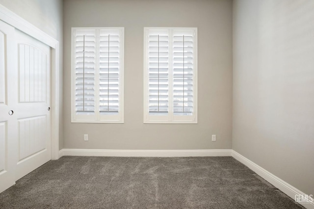 unfurnished bedroom featuring a closet, baseboards, and carpet flooring