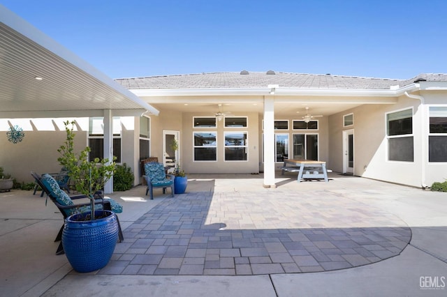 view of patio with fence and ceiling fan