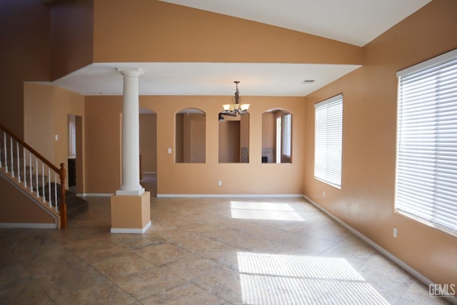 interior space with a healthy amount of sunlight, vaulted ceiling, and ornate columns