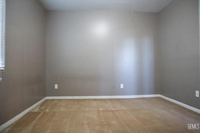 carpeted empty room with baseboards