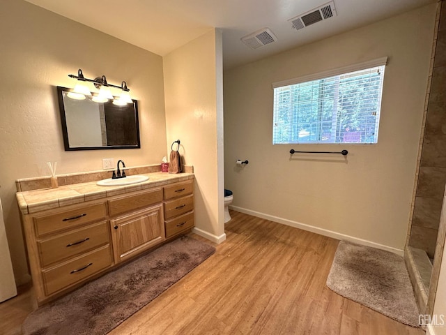 45796 Rocking K Dr, Cal Hot Springs, CA 93207 - full bathroom with wood finished floors, toilet, baseboards, vanity, and tiled shower