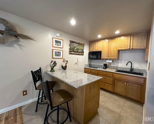 45796 Rocking K Dr, Cal Hot Springs, CA 93207 - kitchen with black appliances, a sink, a kitchen breakfast bar, light tile patterned flooring, and recessed lighting