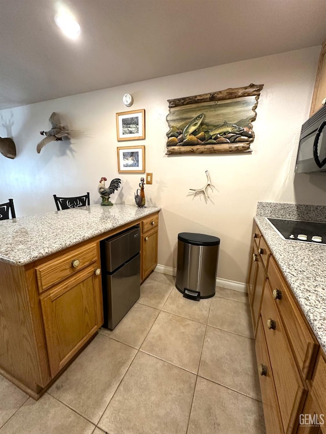 45796 Rocking K Dr, Cal Hot Springs, CA 93207 - indoor dry bar with black appliances, light tile patterned floors, and baseboards