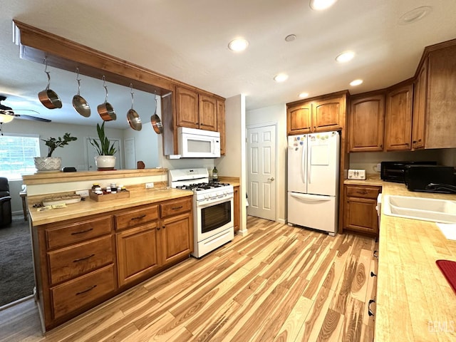 45796 Rocking K Dr, Cal Hot Springs, CA 93207 - kitchen with white appliances, wooden counters, a sink, brown cabinetry, and recessed lighting