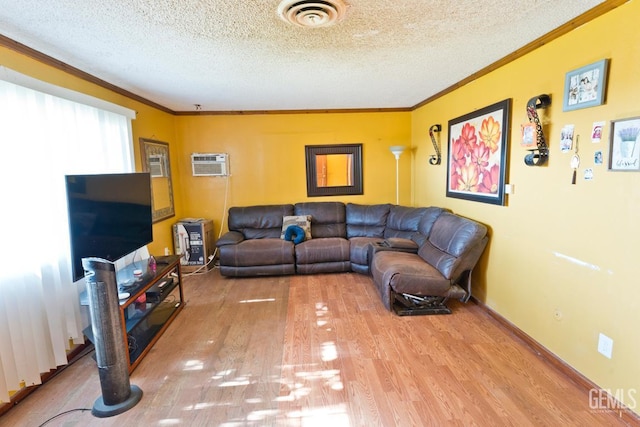 18695 Beech Ave, Shafter, CA 93263 - living room with ornamental molding, light wood-style floors, an AC wall unit, and a textured ceiling