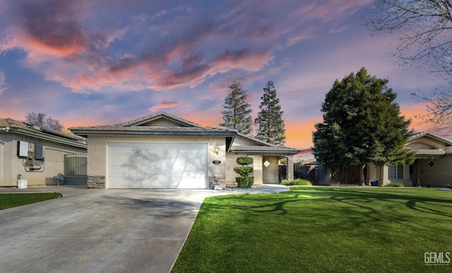 single story home with a garage, concrete driveway, stone siding, a yard, and stucco siding