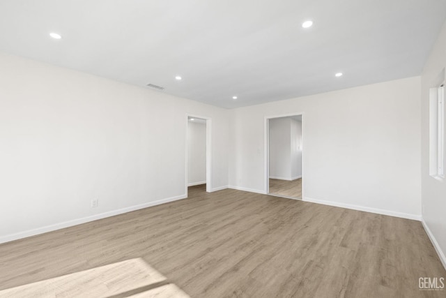 409 Jane St, Bakersfield, CA 93306 - unfurnished room featuring baseboards, visible vents, wood finished floors, and recessed lighting