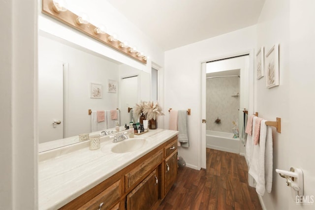 bathroom with shower / tub combination, hardwood / wood-style floors, and vanity