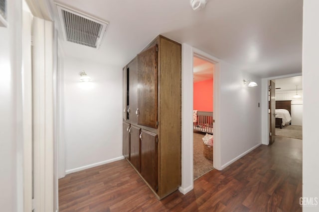 hallway with dark hardwood / wood-style floors