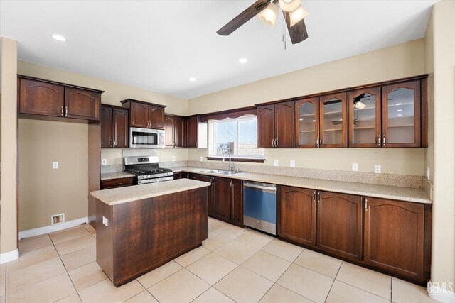 kitchen featuring a center island, sink, ceiling fan, dark brown cabinets, and stainless steel appliances