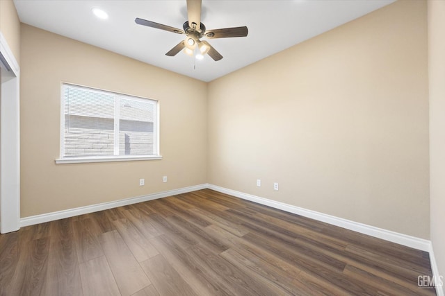 empty room with dark hardwood / wood-style flooring and ceiling fan