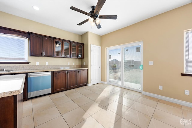 kitchen with dishwasher, ceiling fan, light tile patterned flooring, and dark brown cabinetry