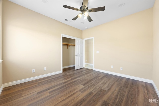 unfurnished bedroom with a closet, ceiling fan, and dark wood-type flooring