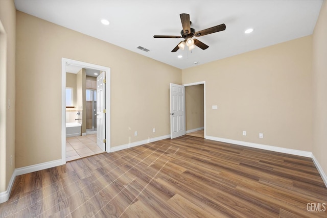 unfurnished bedroom featuring connected bathroom and ceiling fan