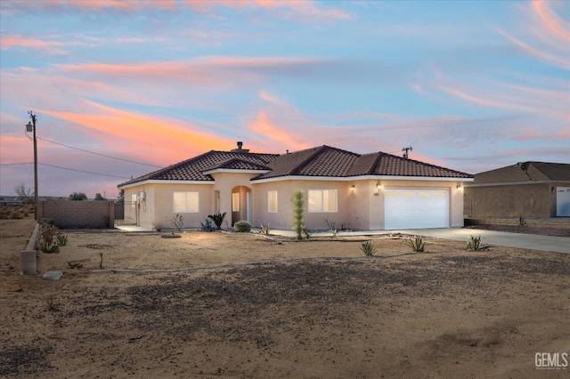 mediterranean / spanish-style home with a garage