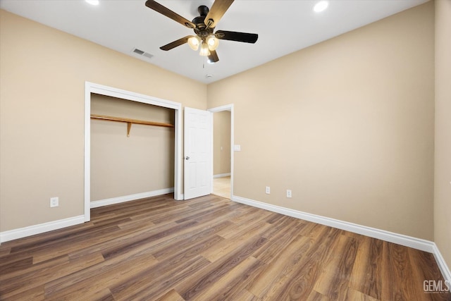 unfurnished bedroom featuring a closet, ceiling fan, and hardwood / wood-style floors