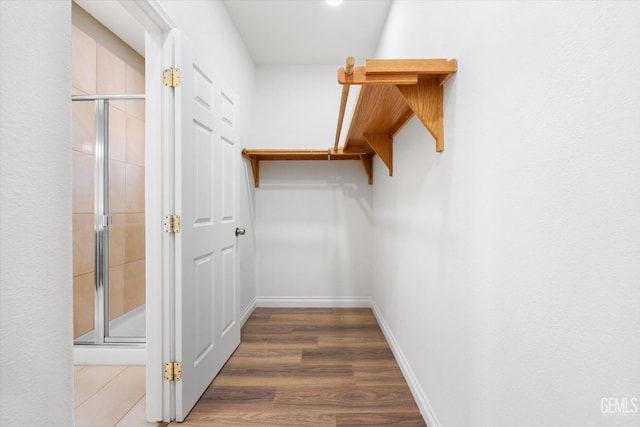 spacious closet with dark wood-type flooring