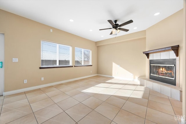 unfurnished living room with a fireplace, light tile patterned floors, and ceiling fan