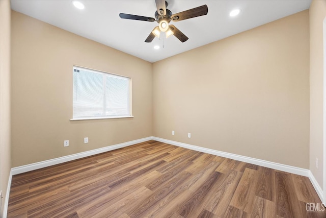 spare room with hardwood / wood-style flooring and ceiling fan