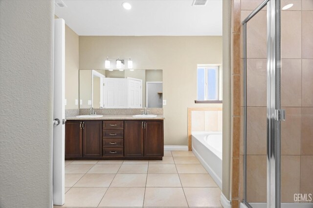 bathroom with tile patterned flooring, vanity, and independent shower and bath