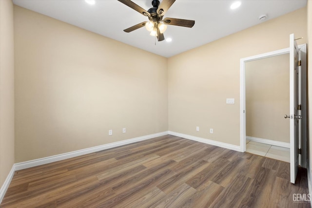 spare room featuring ceiling fan and dark wood-type flooring