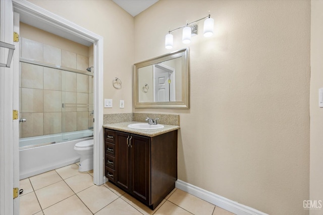 full bathroom with tile patterned floors, combined bath / shower with glass door, toilet, and vanity