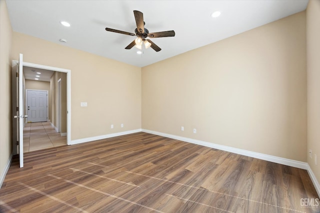 unfurnished room with wood-type flooring and ceiling fan