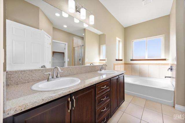 bathroom with tile patterned floors, vanity, and independent shower and bath