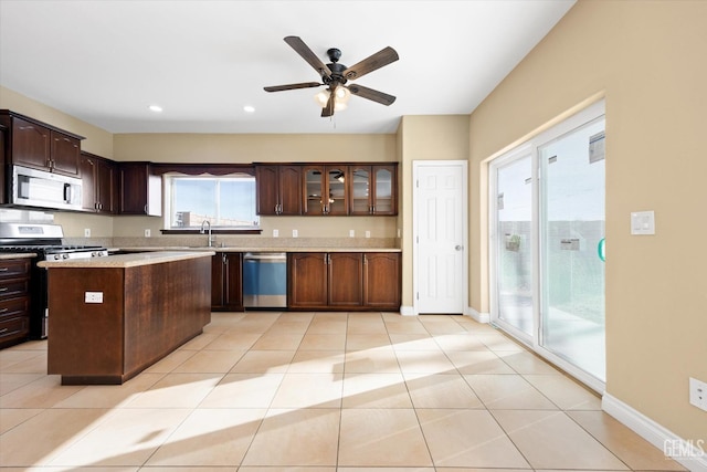 kitchen featuring a kitchen island, dark brown cabinetry, and stainless steel appliances