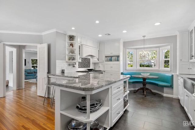 2615 22nd St, Bakersfield, CA 93301 - kitchen featuring white cabinets, open shelves, backsplash, ornamental molding, and custom range hood