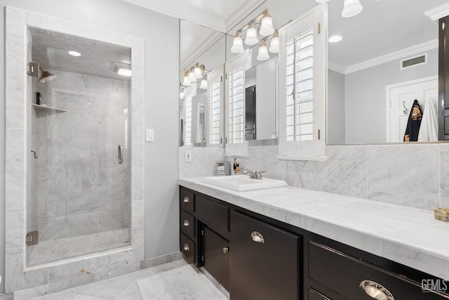 2615 22nd St, Bakersfield, CA 93301 - bathroom with a marble finish shower, vanity, baseboards, ornamental molding, and visible vents