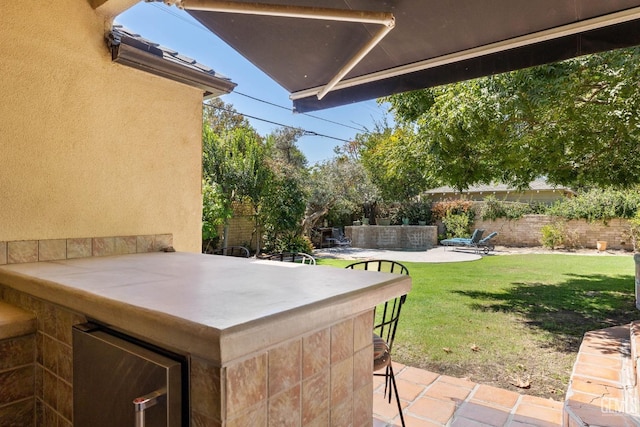 2615 22nd St, Bakersfield, CA 93301 - view of patio featuring fence and outdoor dry bar