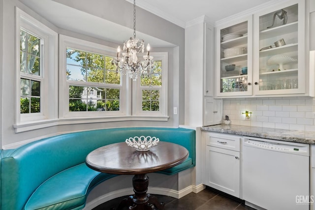 2615 22nd St, Bakersfield, CA 93301 - dining space with dark tile patterned flooring, breakfast area, ornamental molding, and a notable chandelier