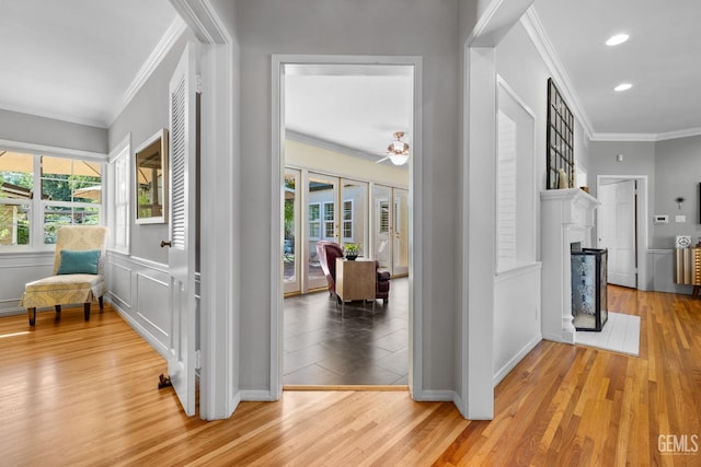 2615 22nd St, Bakersfield, CA 93301 - hallway featuring ornamental molding, a healthy amount of sunlight, and light wood-type flooring