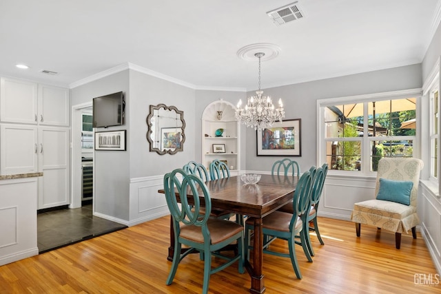 2615 22nd St, Bakersfield, CA 93301 - dining room featuring ornamental molding, a chandelier, visible vents, and light wood-style floors
