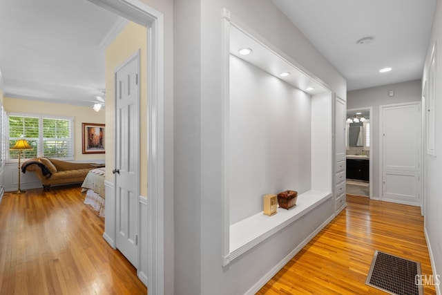 2615 22nd St, Bakersfield, CA 93301 - hall featuring light wood-style flooring, visible vents, recessed lighting, and crown molding