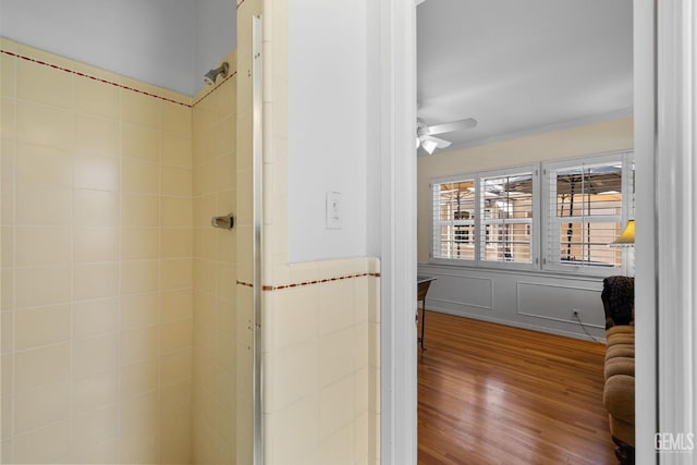 2615 22nd St, Bakersfield, CA 93301 - full bathroom with wood finished floors, a ceiling fan, crown molding, wainscoting, and a stall shower