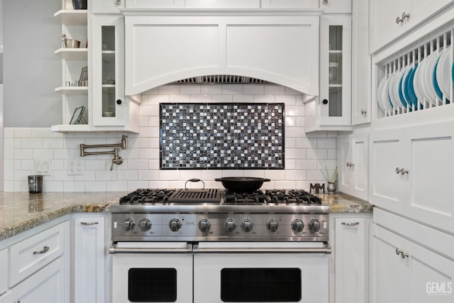 2615 22nd St, Bakersfield, CA 93301 - kitchen with decorative backsplash, glass insert cabinets, double oven range, custom range hood, and white cabinets
