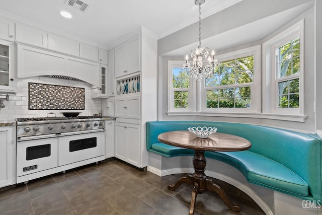 2615 22nd St, Bakersfield, CA 93301 - kitchen featuring white cabinets, breakfast area, double oven range, and visible vents