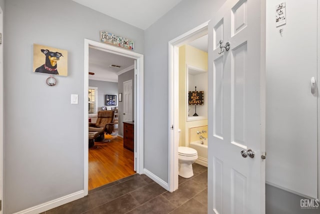 2615 22nd St, Bakersfield, CA 93301 - full bath featuring tile patterned floors, toilet, visible vents, a tub, and ornamental molding