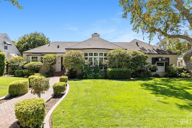 2615 22nd St, Bakersfield, CA 93301 - view of front of house with a chimney, a front yard, and stucco siding