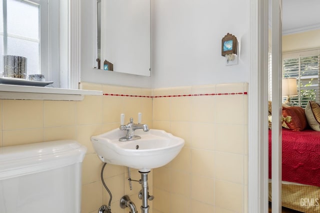 2615 22nd St, Bakersfield, CA 93301 - half bathroom with tile walls and a sink