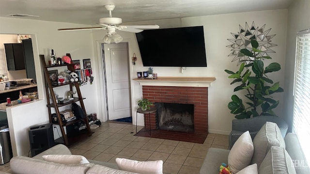 tiled living area featuring visible vents, ceiling fan, and a fireplace