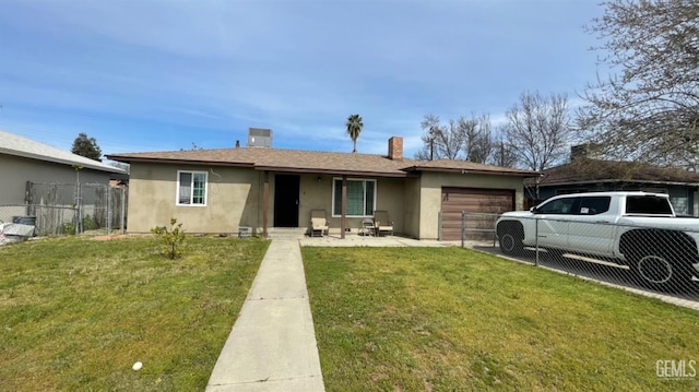 view of front of home with a front yard, fence, a chimney, stucco siding, and a garage